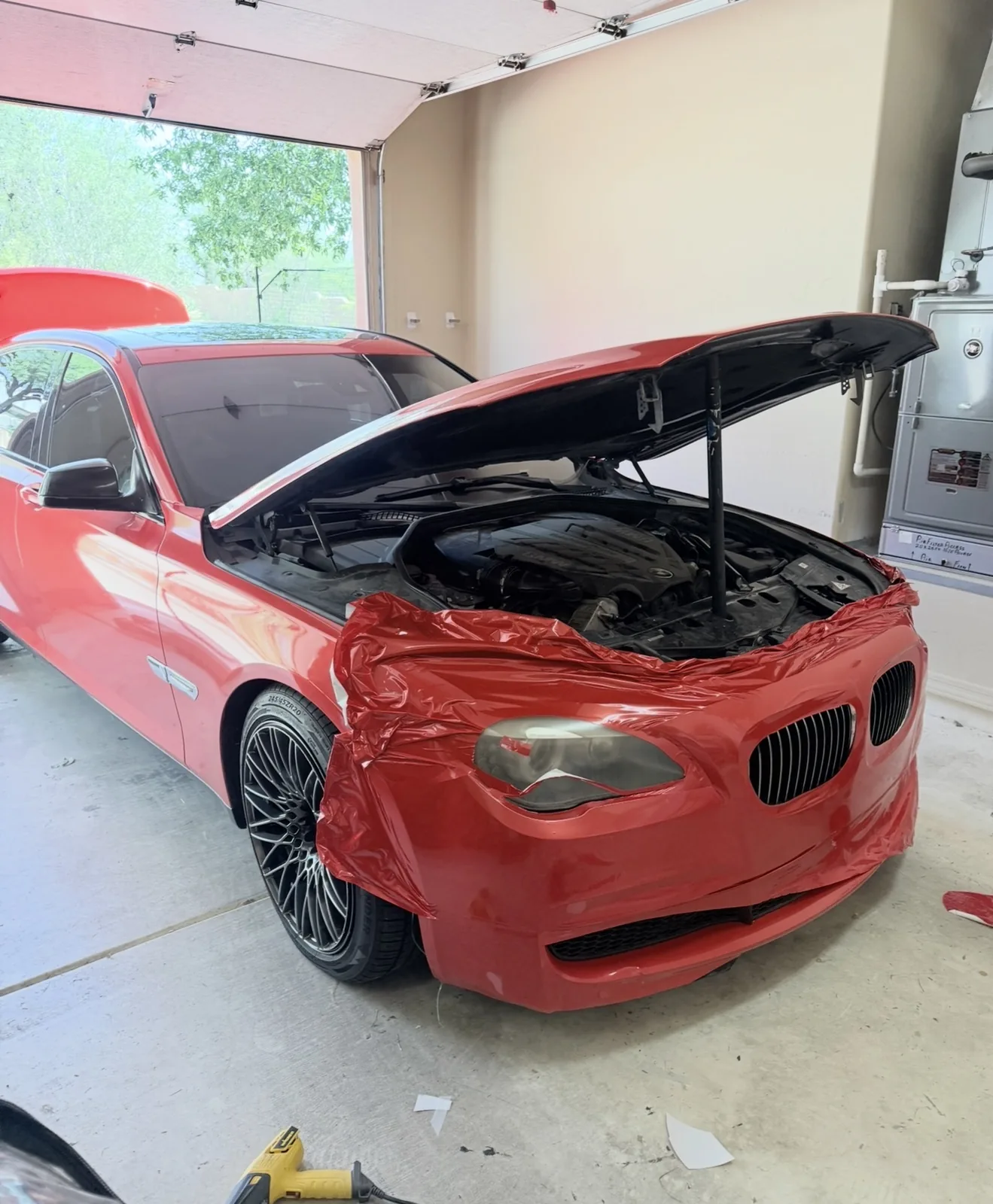 BMW 750Li color change wrap install in progress on front bumper