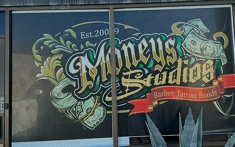 Custom window graphics for Moneys Studios barber shop