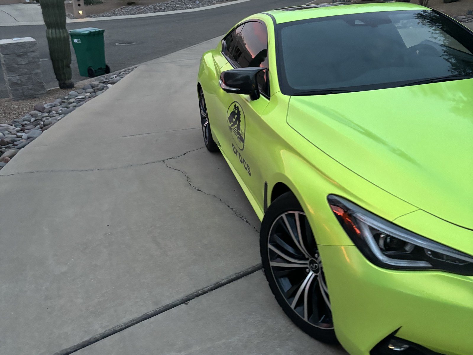 Infiniti Q60 gloss yellow-green color change wrap with Crocs logo